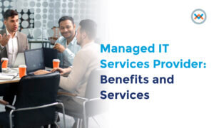 Three professionals meeting around a laptop to discuss managed IT services and business technology.